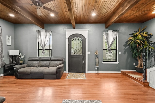 foyer with beamed ceiling, hardwood / wood-style floors, ceiling fan, and wooden ceiling