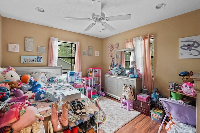 bedroom featuring hardwood / wood-style floors and ceiling fan