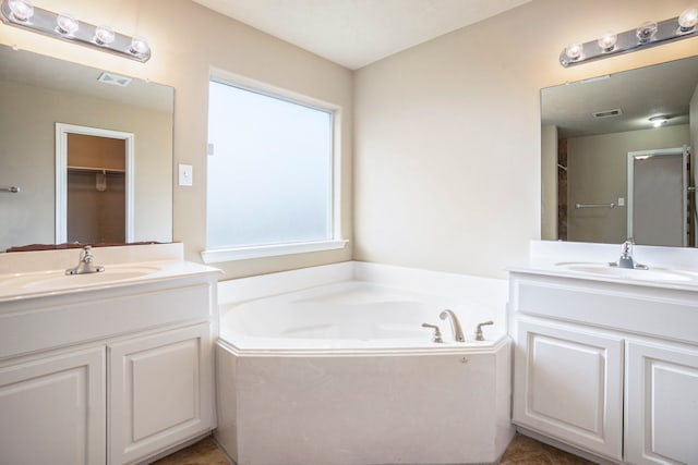 bathroom featuring a sink, visible vents, and two vanities