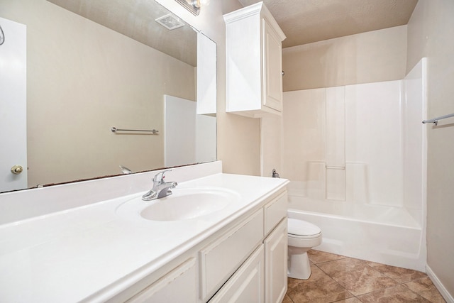 full bathroom featuring bathing tub / shower combination, tile patterned flooring, vanity, a textured ceiling, and toilet