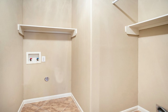 laundry area featuring laundry area, hookup for a washing machine, and baseboards