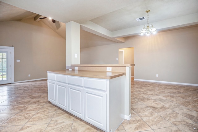 kitchen with visible vents, baseboards, vaulted ceiling with beams, white cabinets, and a chandelier