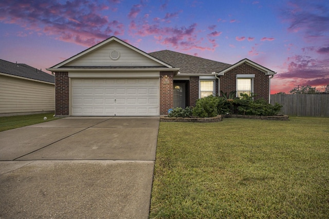 single story home featuring brick siding, fence, concrete driveway, a lawn, and a garage