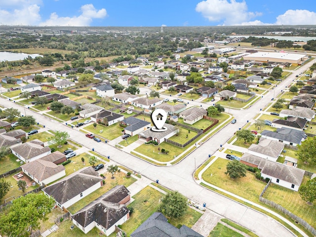 drone / aerial view featuring a residential view and a water view