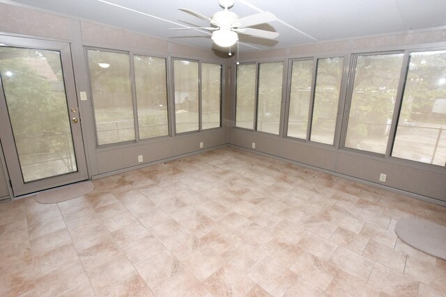 unfurnished sunroom with ceiling fan