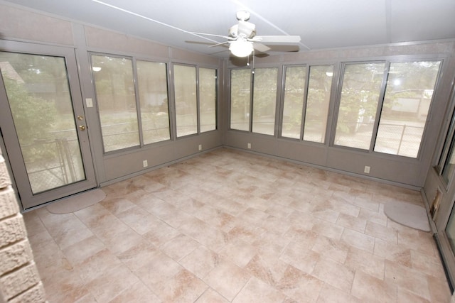 unfurnished sunroom with ceiling fan and vaulted ceiling