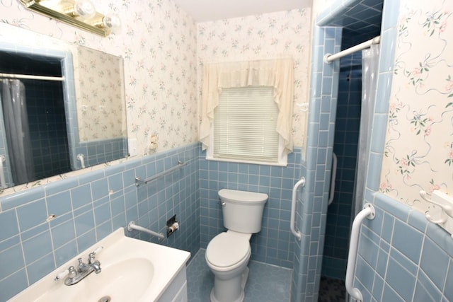 bathroom with a shower with curtain, vanity, tile walls, and toilet