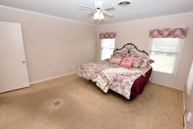 bedroom featuring ceiling fan, light colored carpet, and ornamental molding