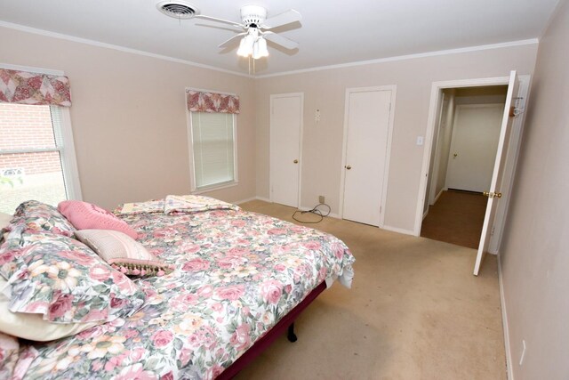 carpeted bedroom with ceiling fan and crown molding