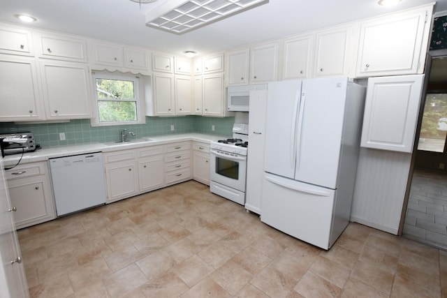 kitchen featuring white cabinetry, white appliances, sink, and tasteful backsplash