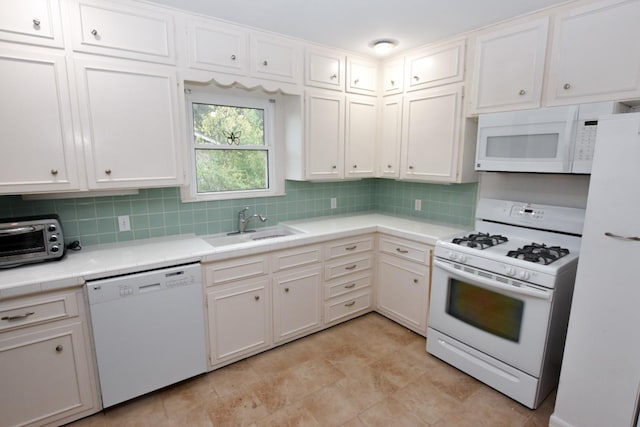 kitchen featuring backsplash, white cabinetry, white appliances, and sink