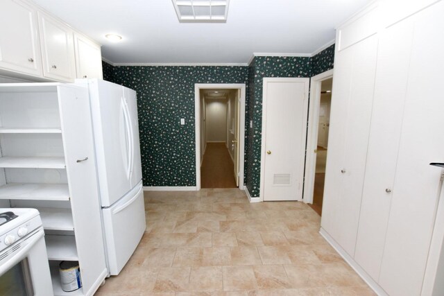 kitchen featuring white cabinetry, white appliances, and ornamental molding