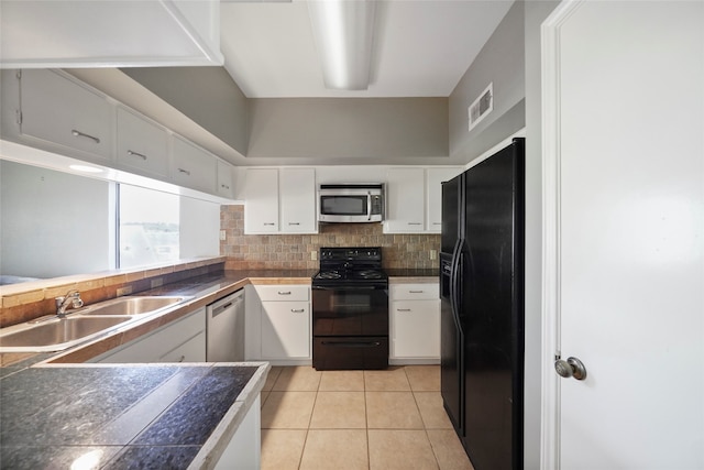 kitchen featuring black appliances, white cabinets, light tile patterned floors, and sink