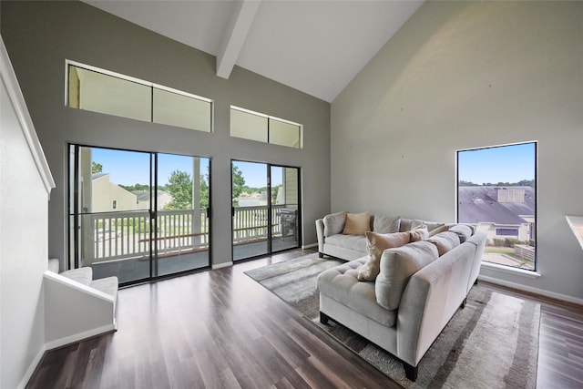 living room featuring beam ceiling, dark hardwood / wood-style flooring, and high vaulted ceiling