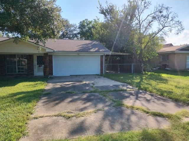 ranch-style house featuring a front lawn and a garage