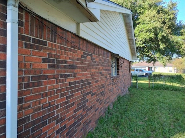 view of property exterior with a lawn