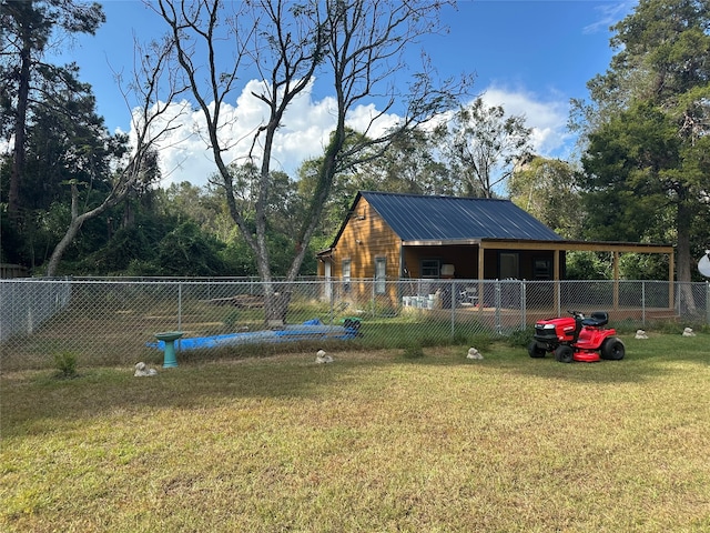 view of property's community featuring a yard and fence