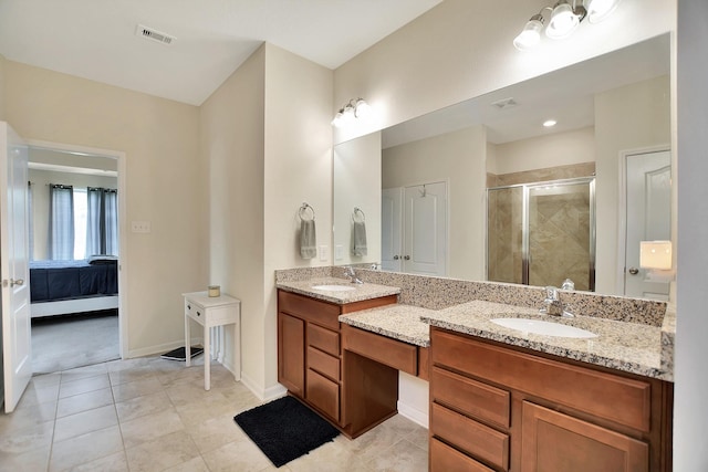 bathroom with tile patterned floors, vanity, and walk in shower