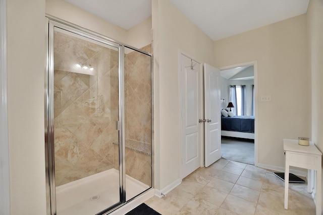 bathroom with tile patterned flooring and a shower with door