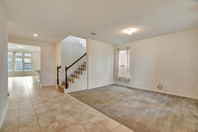 carpeted empty room featuring a healthy amount of sunlight