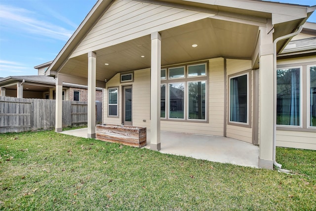 back of house featuring a yard and a patio