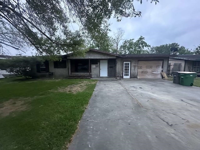 single story home with a garage and a front lawn