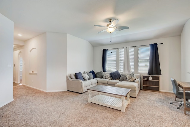 living room featuring light colored carpet and ceiling fan