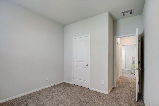 unfurnished bedroom with light carpet