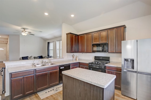 kitchen with black appliances, a kitchen island, kitchen peninsula, light hardwood / wood-style floors, and lofted ceiling