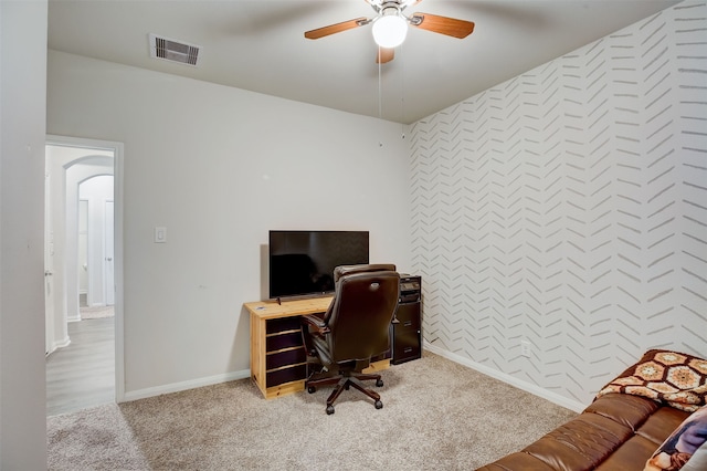 carpeted office featuring ceiling fan