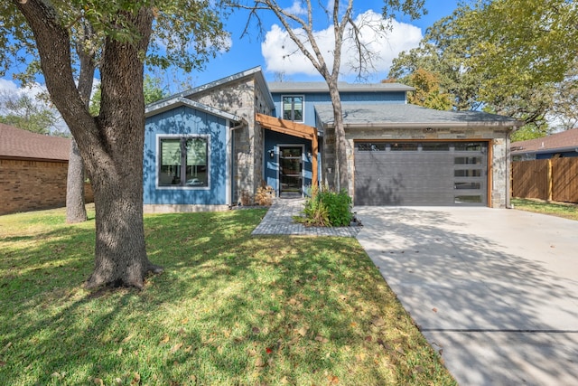 view of front of property with a front yard and a garage