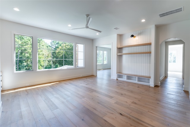 unfurnished living room with light hardwood / wood-style flooring and ceiling fan