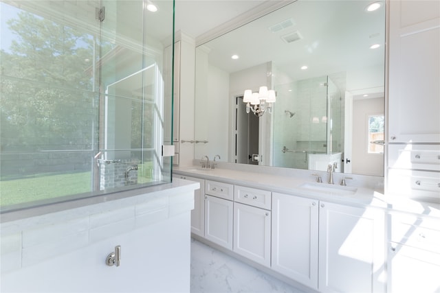 bathroom featuring vanity, an inviting chandelier, and a shower with door