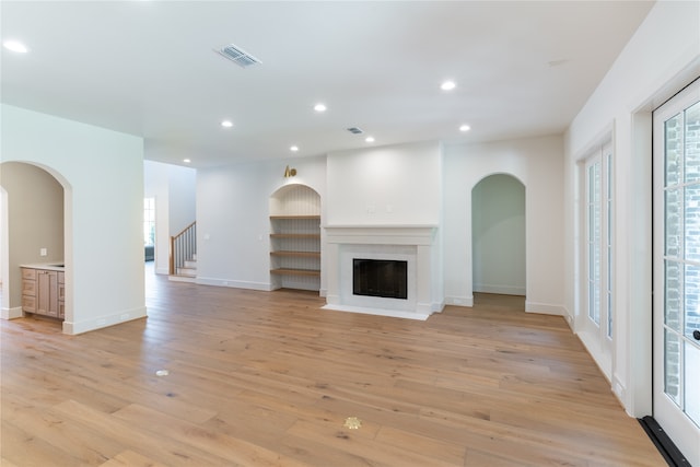 unfurnished living room with light hardwood / wood-style flooring