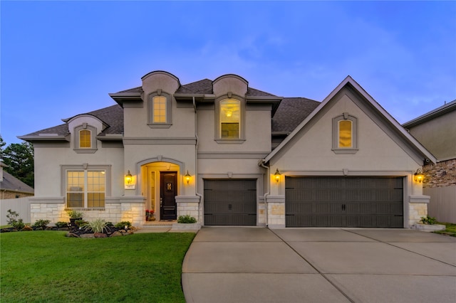 french country inspired facade featuring a front yard and a garage