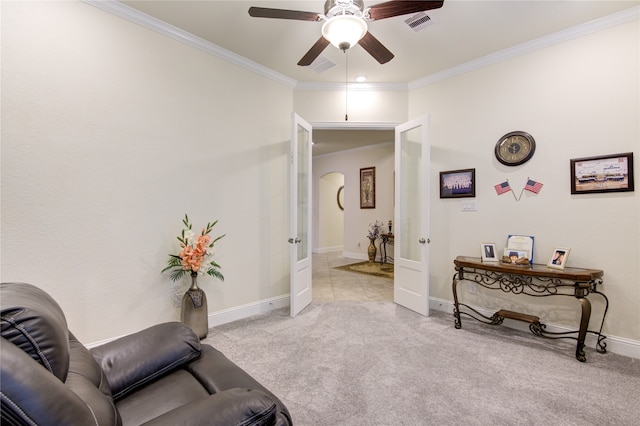 sitting room with ceiling fan, light colored carpet, french doors, and crown molding