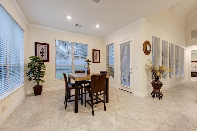 dining room with ornamental molding and light tile patterned floors