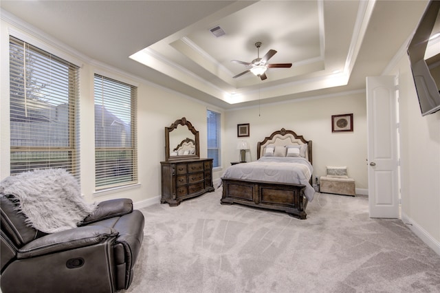 carpeted bedroom featuring ornamental molding, ceiling fan, and a tray ceiling