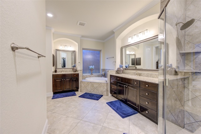 bathroom with ornamental molding, vanity, and independent shower and bath