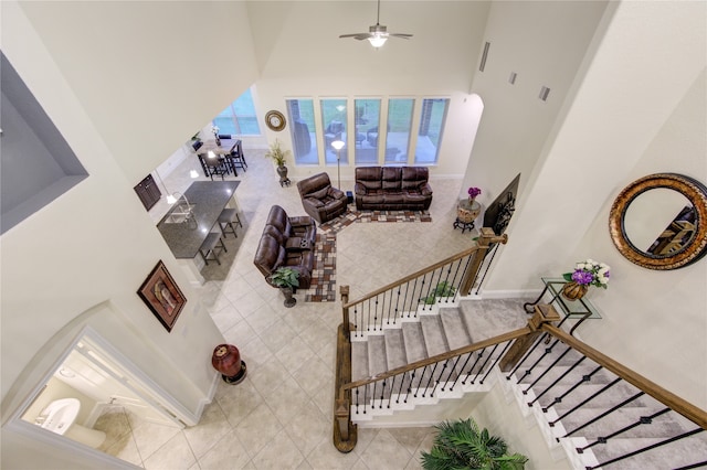 living room featuring a high ceiling and ceiling fan