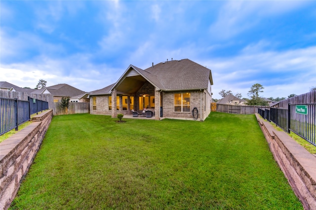 rear view of house with a yard