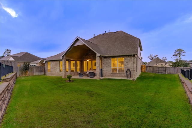 back of property with a patio and a yard