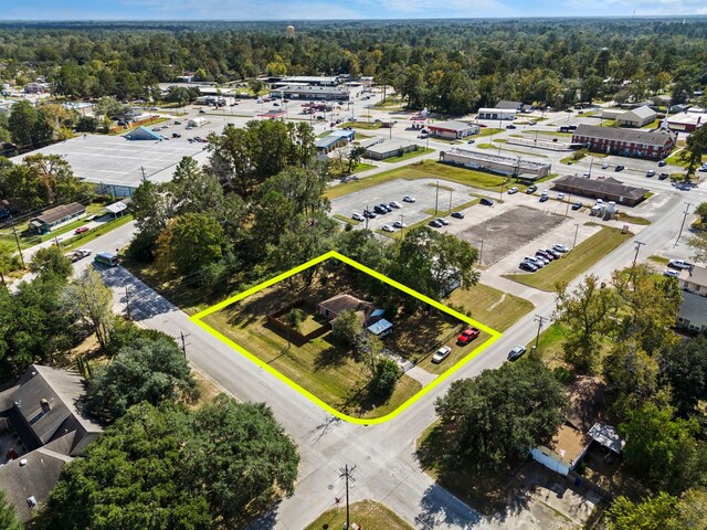 220 N William Barnett Ave, Cleveland, TX 77327 - aerial overview of property's location with a heavily wooded area and property parcel outlined