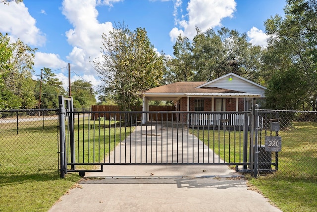 view of gate with a yard and a carport