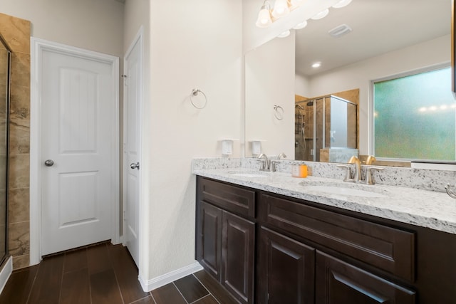 bathroom with vanity and a shower with shower door