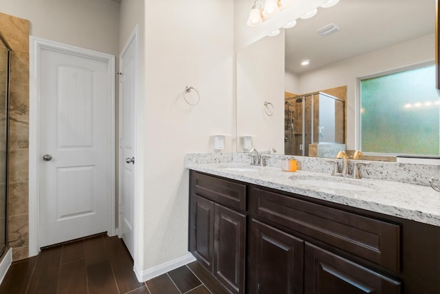 bathroom featuring vanity and a shower with door