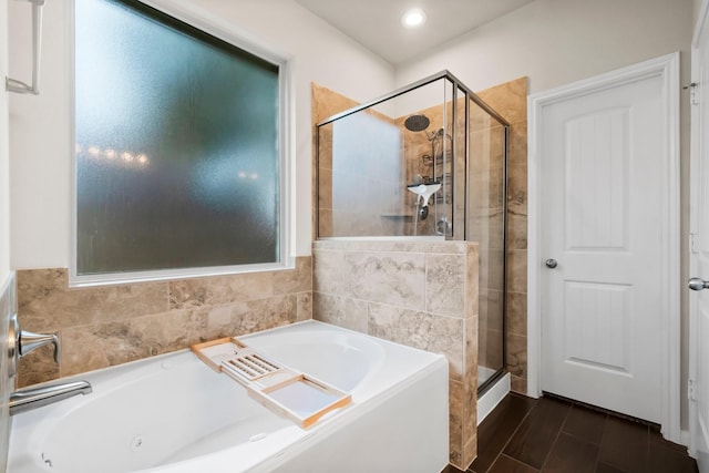 bathroom featuring separate shower and tub