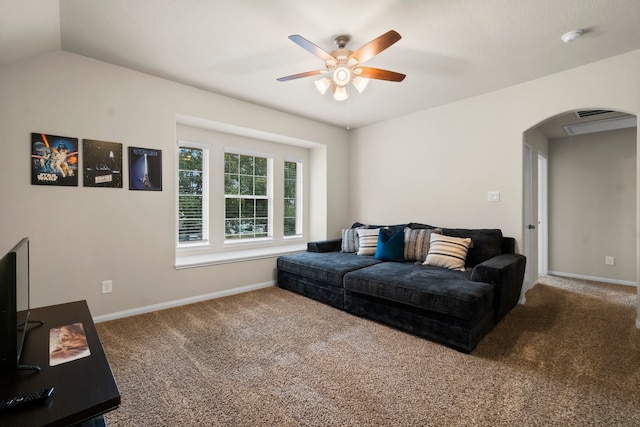 carpeted living room with ceiling fan and lofted ceiling