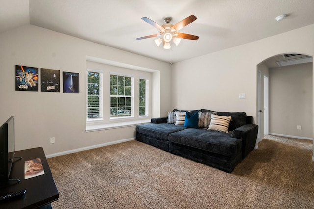 living room with ceiling fan, vaulted ceiling, and carpet