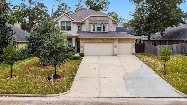 view of front of house with a garage and a front lawn